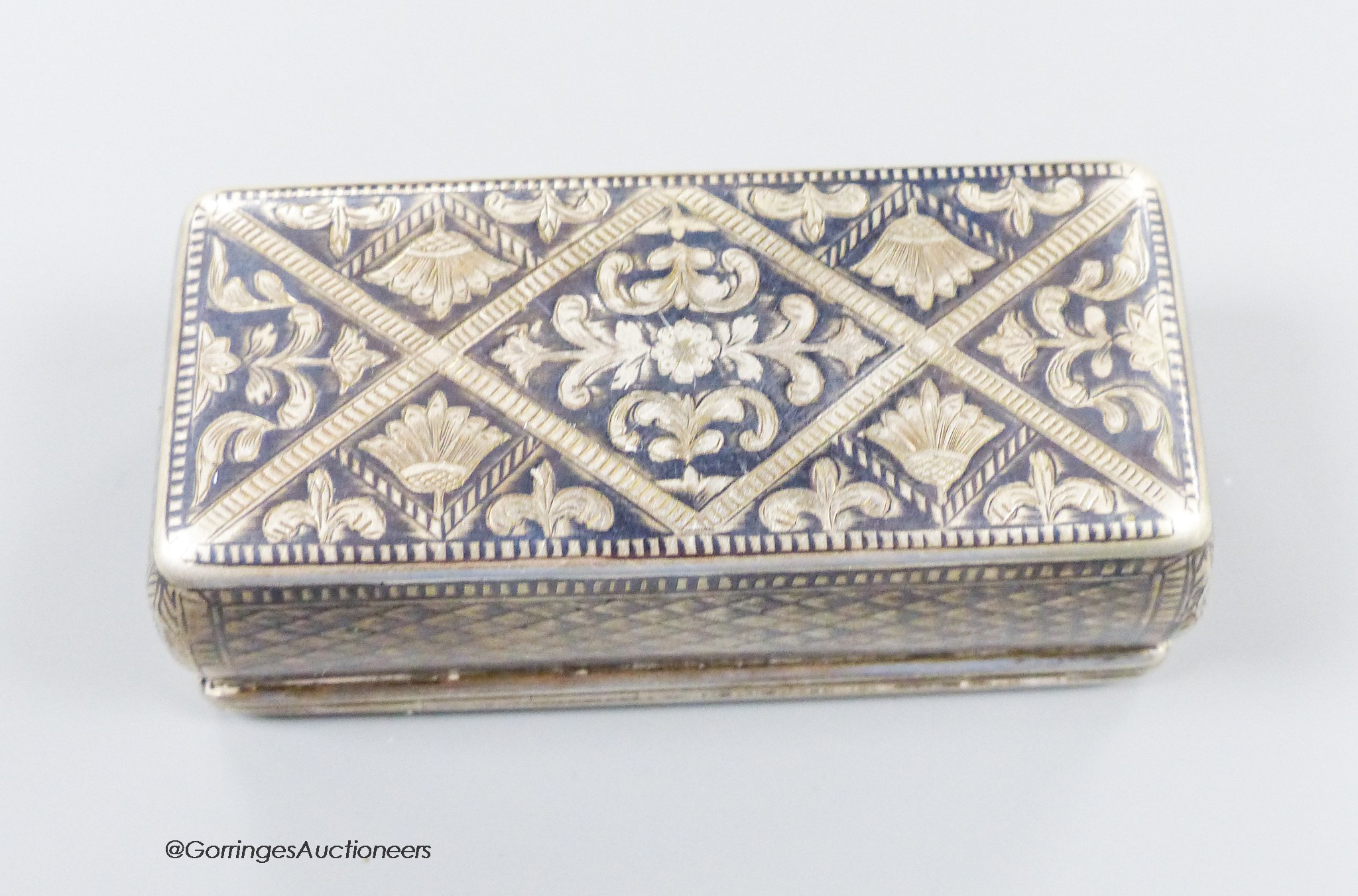 A 19th century Russian 84 zolotnik and niello rectangular snuff box, with trellis and scroll decoration, 87mm, (date rubbed), 107 grams.